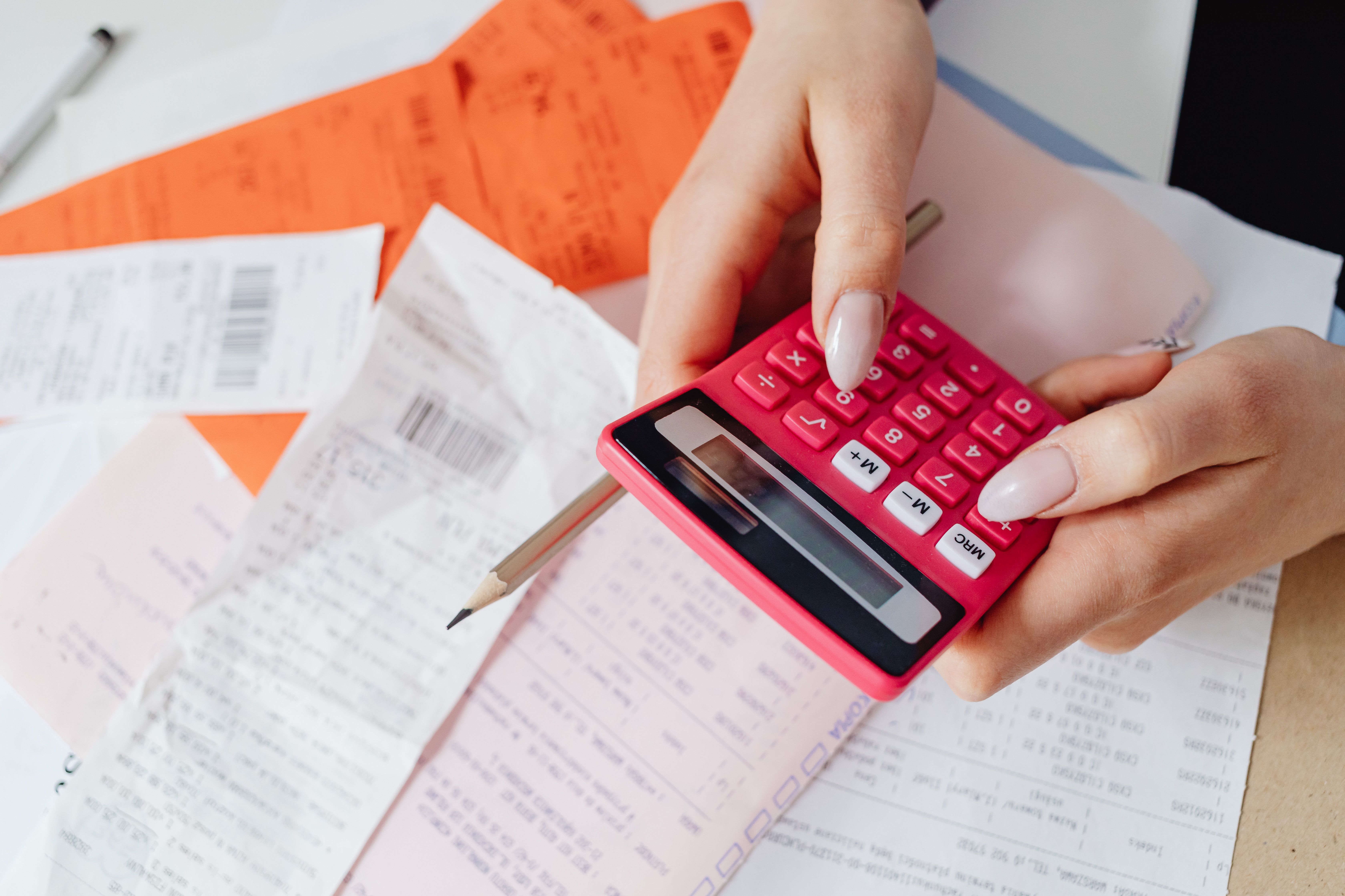 Calculator, receipts, and documents representing law firm billing and expenses