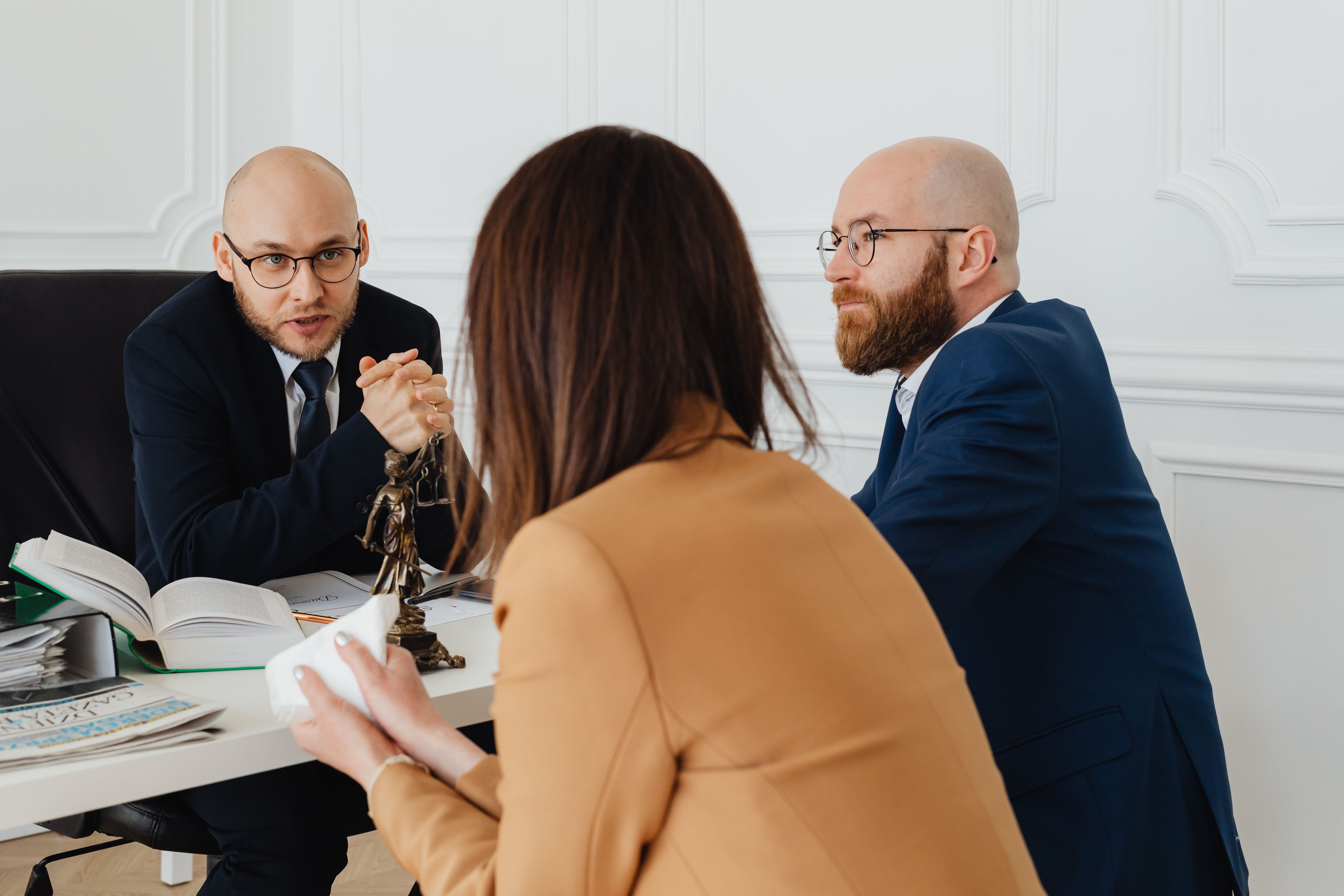 Professional discussion among lawyers in a modern office focusing on legal case strategy