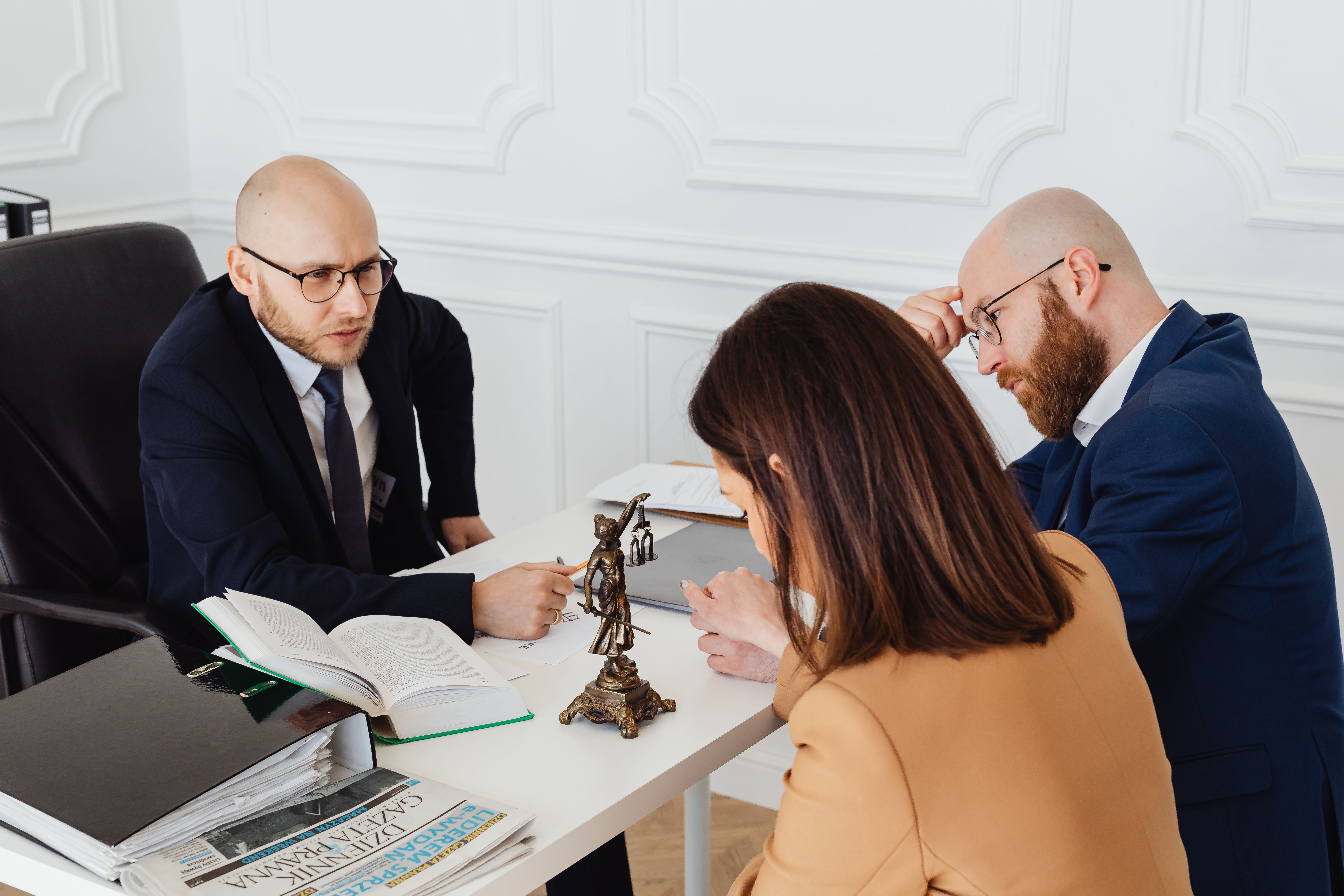 Lawyer consulting clients in a modern office about their legal matter