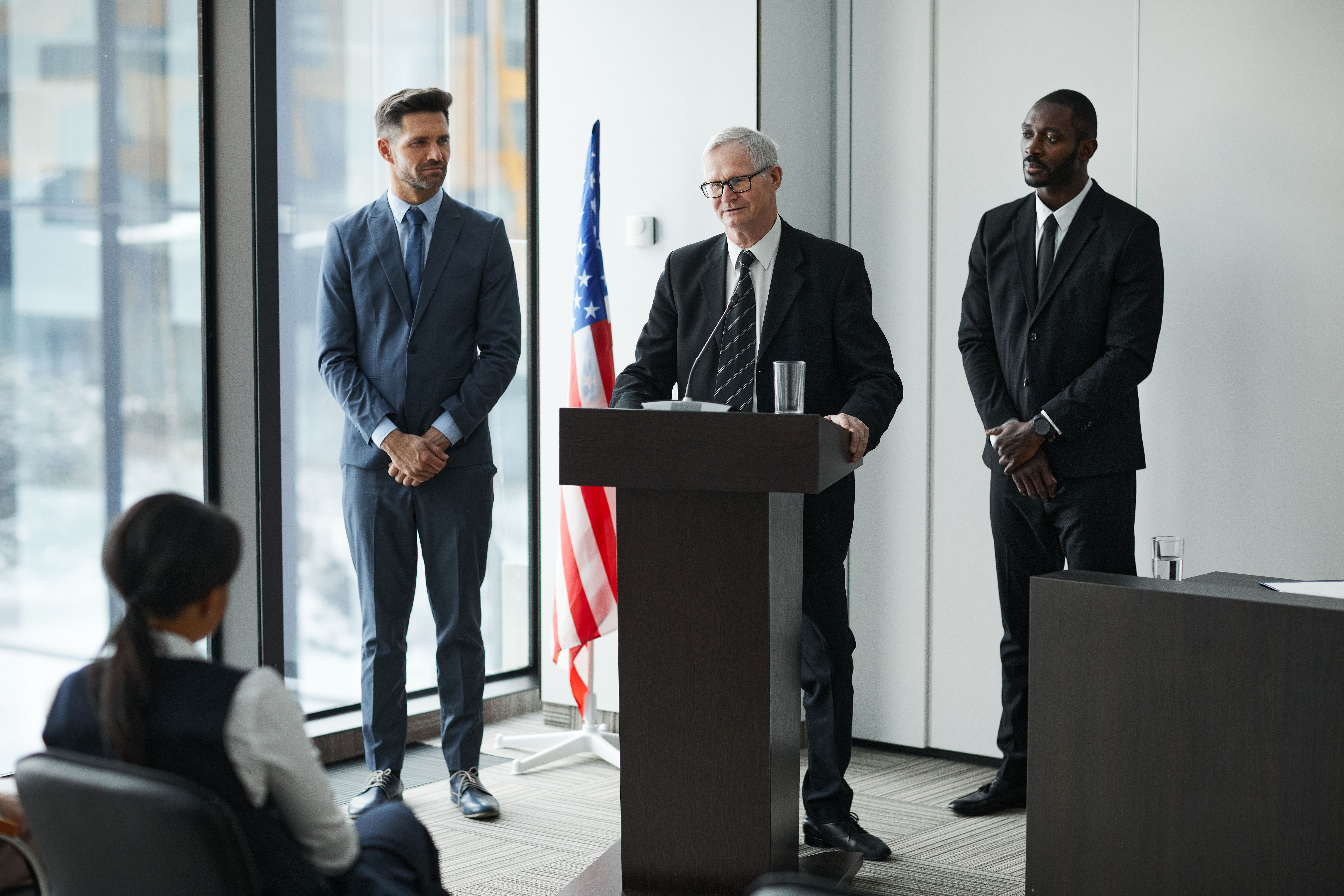 Public officials speaking at a formal event, representing accountable leadership and public communication.